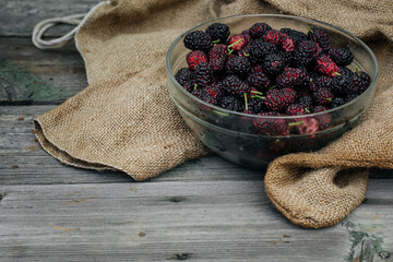 Mulberry isolated on a wooden background. Ripe mulberry fruit. Healthy food from mulberry fruit has...