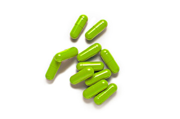 Green capsule pills isolated on white background