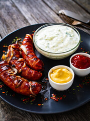 Grilled sausages on wooden board
