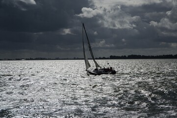 Idyllic view of a sailboat on a cloudy day - perfect for wallpaper