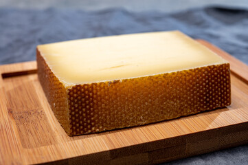 Block of Swiss medium-hard matured cheese gruyere used for baking, quiche, fondue, sandwiches