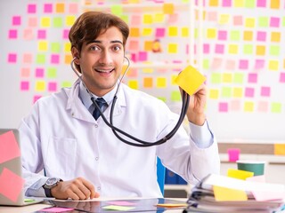 Male doctor with many conflicting prioritites