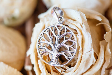 Detail of sterling silver pendant in the shape of tree in mandala