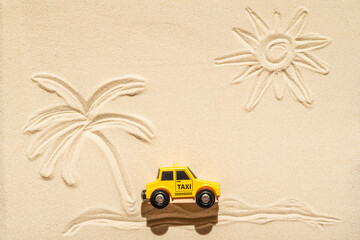 Toy taxi car, sun, palm tree on beach sand. Concept. Fast and cheap taxi booking service. Travel. Summer time. Creative