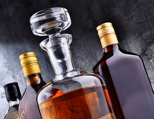 Carafe and bottles of assorted alcoholic beverages.