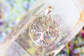 Detail of sterling silver pendant in the shape of tree in mandala