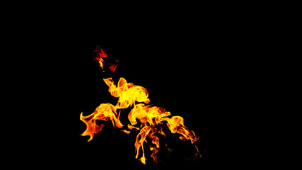 Fire flames on black background isolated. Burning gas or gasoline burns with fire and flames. Flaming burning sparks close-up, fire patterns. Infernal glow of fire in the dark with copy-space
