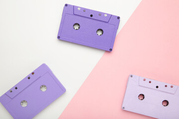 Old colorful cassettes on pink and white background. Music day