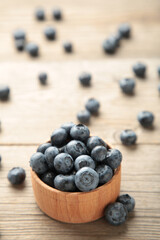 Blueberries in a bowl on grey wooden table. Vertical foto