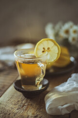 healthy served drink in the morning. A glass cup of green natural tea, lemon and chamomile