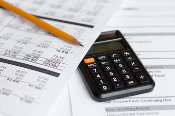 Financial Document with Pencil and Calculator