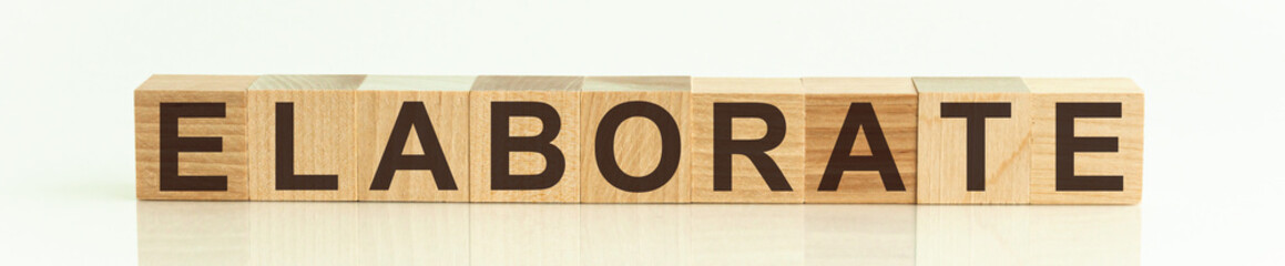 The word ELABORATE written on wooden cubes isolated on a white background.