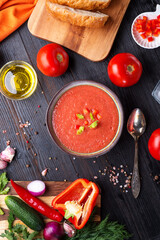  classic spanish raw eating cold soup Gazpacho served at black wooden table. flat lay. food recipe. healthy concept.