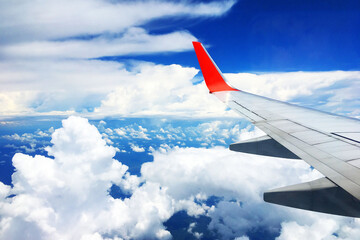 Fototapeta premium beautiful landscape view background of sky above cloud plane's window and see plane's wing