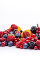 heap of assorted delicious summer fruits on white background