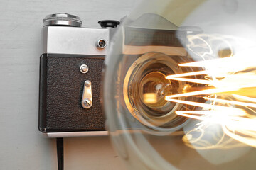 Retro lamp from an old camera with an Edison lamp on a gray background. Concept is a good idea.