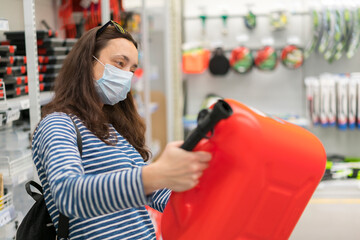 Woman in protective mask in a store with a canister. pandemic concept. Pandemic Shopping