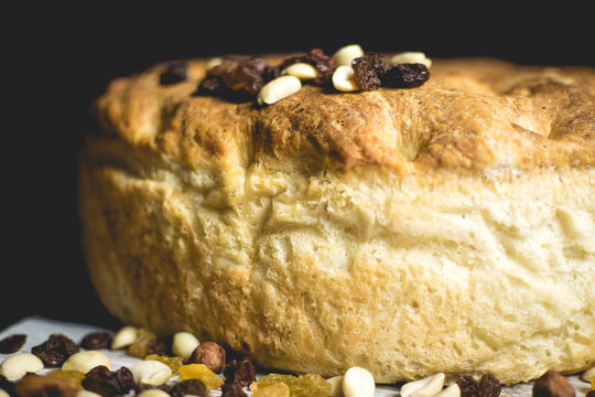 Freshly Baked Loaf of Bread with nuts on the top.