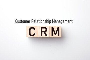Customer Relationship Management : Business text on wood block on White background.