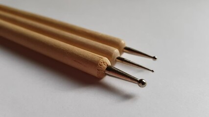 Three dots for nail art on a white table, close-up