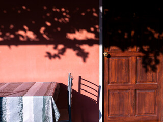 Orange-red Wall with Wooden Door and The Table and Chair