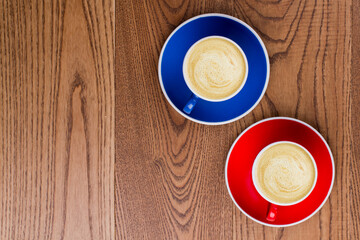 Flat lay cups of coffee and cappuccino on rustic table. Topview and copy space.