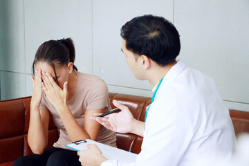 Asian Psychiatrist (MD) man is counseling and encouraging for caucasian Female have mental health problems in clinical depression life. Major depressive disorder patients and doctor office Concept.