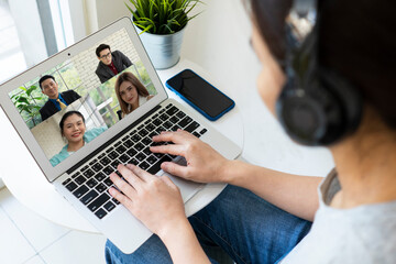 Asian businesswoman using computer to work from home via video conference with clients during covid-19 or coronavirus outbreak. technology and business concept