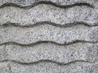 close up of a wave pattern made in a gray stone