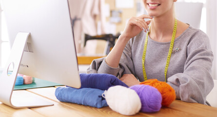 Fashion designer using tablet computer in the studio