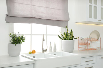 Ceramic sink and modern tap in stylish kitchen interior