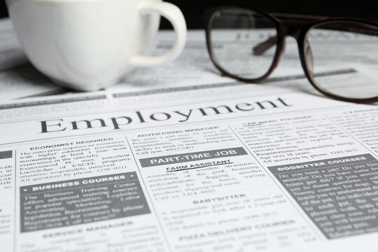 Cup and glasses on newspaper. Search concept