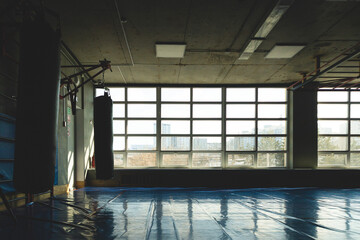 The interior of the gym and a place for group classes. Silhouette photo in front of the window