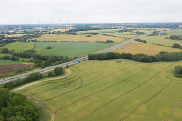  drone flies over the Mecklenburg landscape with its motorway and wind turbines