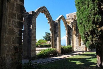 Fototapeta na wymiar Bellapais Abbey, White Abbey, Abbey of the Beautiful world. Arches against the blue sky.