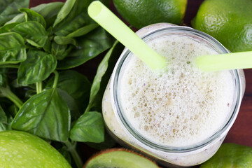 Summer cold drink smoothie kiwi lime. Bright, juicy, green fruit cocktail with ice on the table, top view, concept diet and healthy food