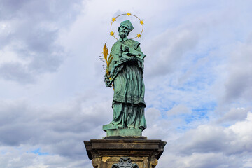 Fototapeta na wymiar Statue of John of Nepomuk on Charles Bridge in Prague, Czech Republic