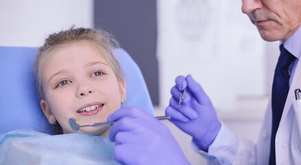 Little girl sitting in the dentists office