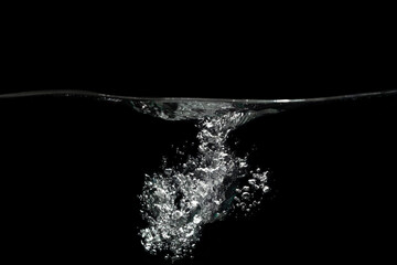 Water splash with air bubbles water on black background.