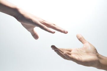 Two male hands reaching towards each other on isolated white background