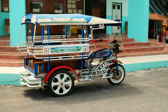 Motor tricycle car before a vintage movie theater