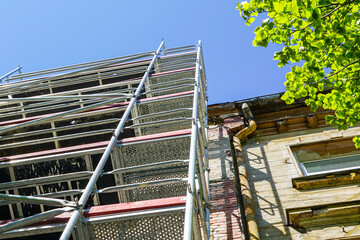 scaffolding assembled at a historic house before facade repairs