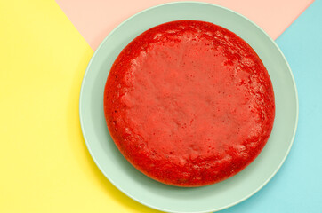Pie of red color on a colorful background. Lingonberry pie on a blue dish. Festive food.