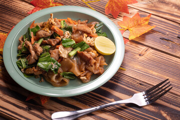 Fried noodles with pork and vegetables. Popular Thai food