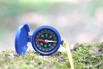 round compass on natural background as symbol of tourism with compass, travel with compass and...