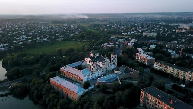 Aerial view of Monastery of the Barefoot Carmelites at sunset, Medieval Catholic ancient fortress in Berdichiv city, Ukraine. Monastery of the Barefoot Carmelites, Aerial survey of Monastery of the Ba