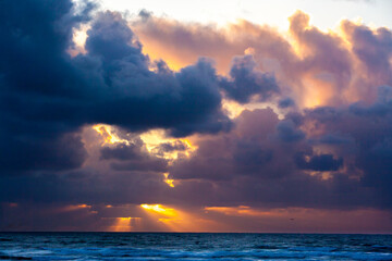 Fototapeta na wymiar Cloudy sunset with sun rays at Seaside, Oregon