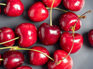 top view of juicy bright sweet cherries on a dark background. Healthy food, flat lay
