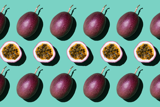 Colorful fruit pattern of fresh passion fruit on pastel green background.