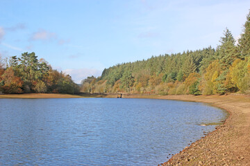Fototapeta na wymiar Reflections in Tottiford Reservoir, Devon, in Autumn 